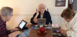 After breakfast three seniors work on three different digital devices.